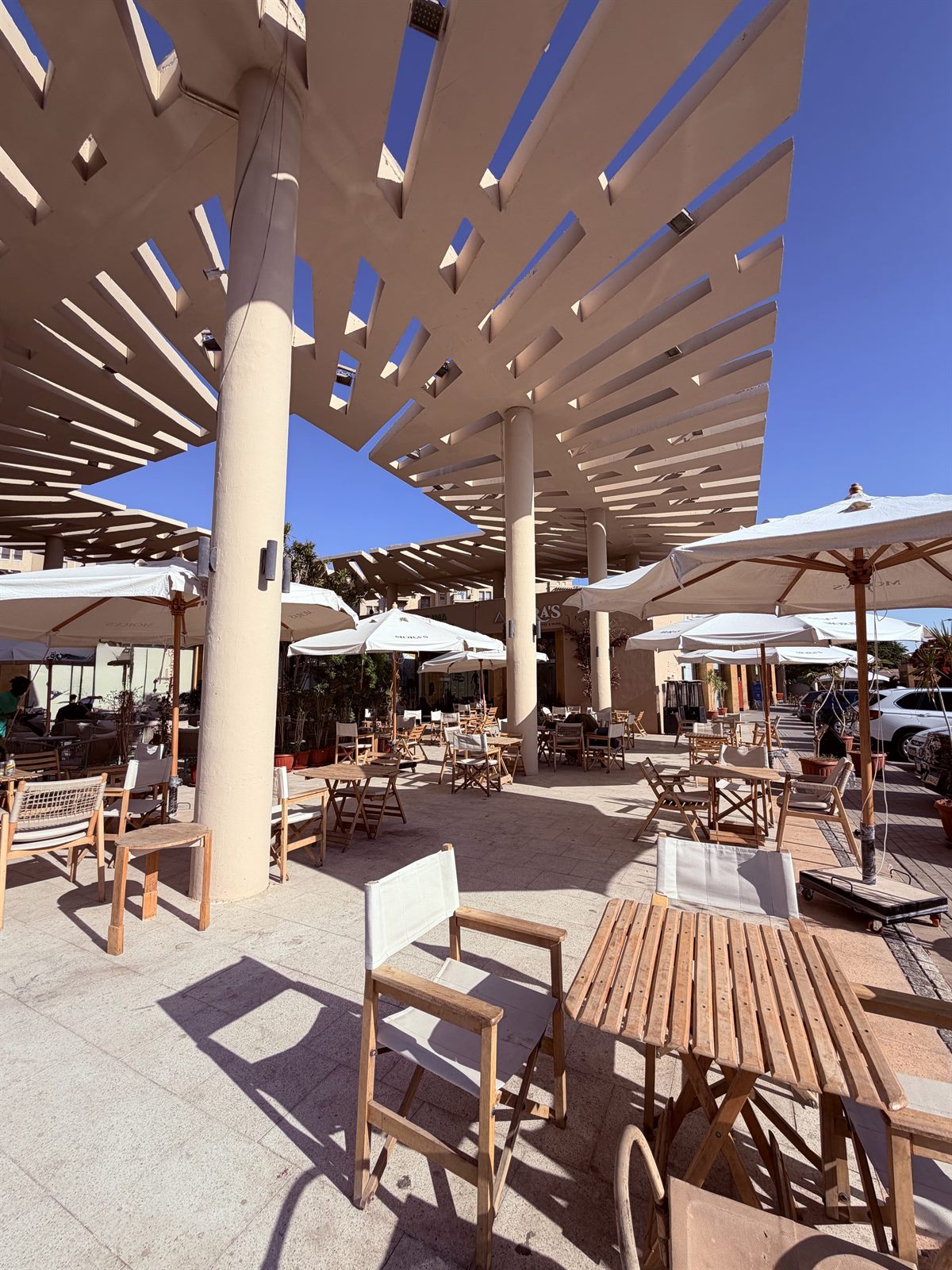 Mora's outdoor seating area shaded by the pergola